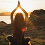 Mujer practicando yoga al aire libre, transmitiendo equilibrio, relajación y conexión interior. Ideal para reflejar bienestar y empoderamiento personal.