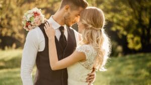 Pareja de recién casados sonríe mientras un fotógrafo profesional captura un momento especial de su boda con un estilo natural y auténtico.