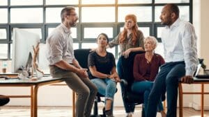 Grupo de profesionales en una reunión de trabajo, analizando estrategias para mejorar la gestión del talento en la empresa.