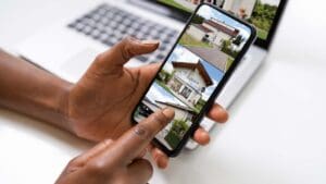 Persona buscando vivienda en España a través de su móvil con una app inmobiliaria.