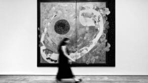 Artista en una galería de arte performativo interactuando con el público durante una acción en vivo en un espacio contemporáneo de Madrid
