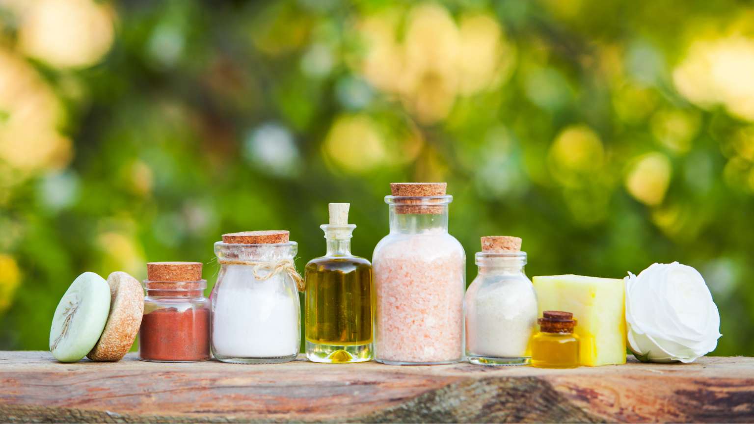 Jabones naturales artesanales y productos de cosmética expuestos en un entorno vegetal, rodeados de hojas y flores, en armonía con la naturaleza.
