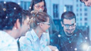 Equipo de trabajo en oficina conectada usando soluciones de telecomunicaciones seguras y eficientes para mejorar la productividad empresarial