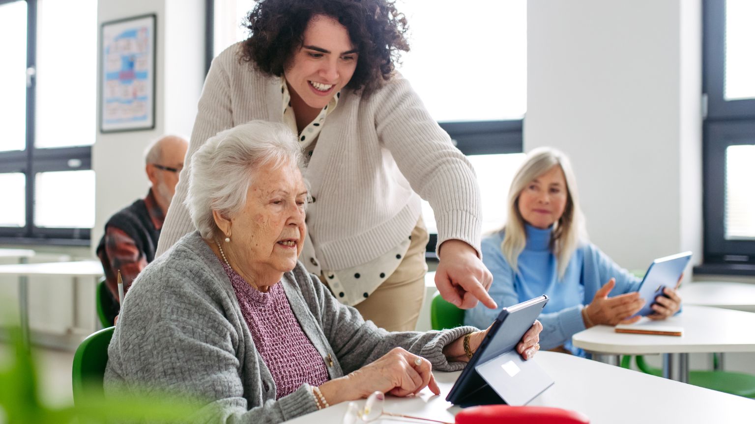 Mujer mayor acompañada por una profesional en una sesión de estimulación cognitiva para detectar señales tempranas de deterioro