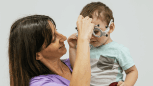 Niño con problemas de aprendizaje realizando ejercicios de visión infantil en clase.