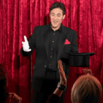 Entretenimiento para eventos con un mago actuando frente a invitados sonrientes.