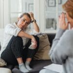 Mujer adulta en terapia emocional conectando con sus emociones profundas para sanar traumas de apego desde una perspectiva psico corporal e integradora