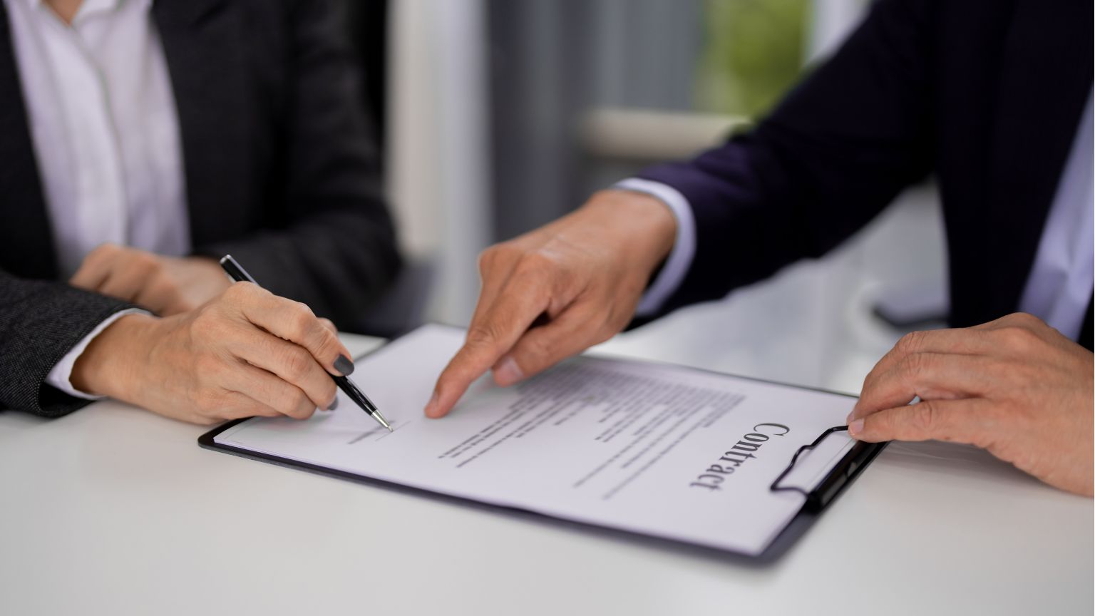 Firma de contrato laboral entre empresa y trabajador con asesoría legal para evitar problemas jurídicos en la contratación