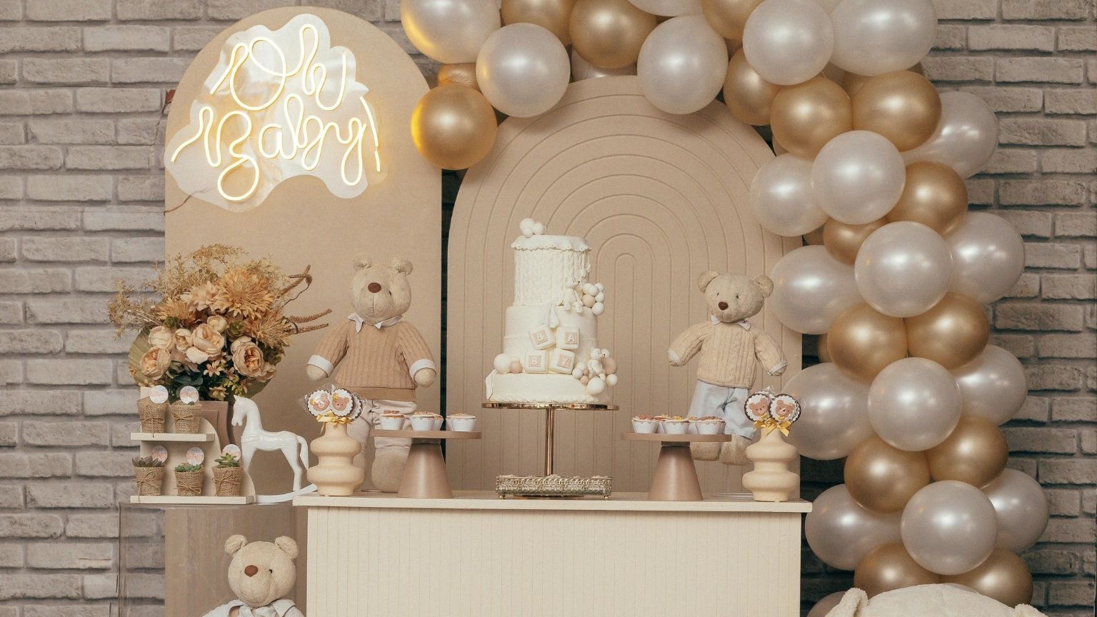 Celebración de baby shower en un local decorado con luz natural y mesa dulce temática