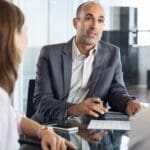 Reunión entre asesor financiero y cliente planificando inversiones y gestión patrimonial