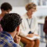 Family therapy session, family sitting with therapist, group counseling
