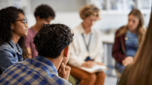 Family therapy session, family sitting with therapist, group counseling