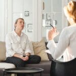 Mujer reflexionando en casa durante una crisis existencial a los 30 o 40 buscando mentoría de crecimiento personal