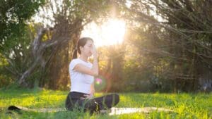 Mujer practicando ejercicios somáticos en el suelo para mejorar la conciencia corporal y reducir el estrés.